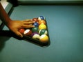 Hand preparing pool balls in triangle rack on the billiard table Royalty Free Stock Photo