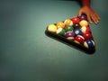 Hand preparing pool balls in triangle rack on the billiard table with copy space Royalty Free Stock Photo