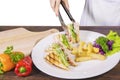 Hand preparing sandwich on a plate Royalty Free Stock Photo