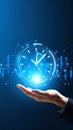 Hand presenting glowing digital clock with financial charts and data visualization Royalty Free Stock Photo