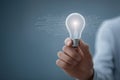 Hand presenting light bulb with digital connections on blue background innovative idea smart technology and creative business Royalty Free Stock Photo