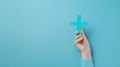 Hand Holding Blue Plus Sign.AI generated image Royalty Free Stock Photo