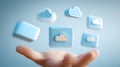 Hand presenting cloud computing concept with floating icons on a blue background Royalty Free Stock Photo