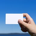 Hand presents white card on blue