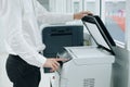 Hand press button on panel of printer scanner or laser copy machine in office Royalty Free Stock Photo