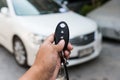 A hand press button of remote control car key to open a car door Royalty Free Stock Photo