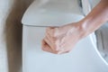 Hand press and flush toilet. Cleaning, Lifestyle and personal hygiene concept Royalty Free Stock Photo