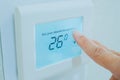 Hand press the touch screen panel of air conditioner to increase the temperature. Energy saving concept Royalty Free Stock Photo