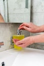 Hand presses the liquid soap dispenser in the bathroom Royalty Free Stock Photo