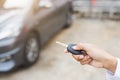 Hand presses on the remote control to lock car Royalty Free Stock Photo