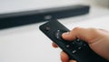 Hand Pressing Button On Black TV Remote Control. Royalty Free Stock Photo