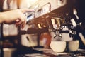 Hand pressing the button on a coffee machine. Coffee preparation. Royalty Free Stock Photo