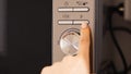 Hand pressing button on modern microwave oven control panel close up Royalty Free Stock Photo