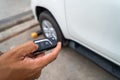 Hand pressing the button on the remote to lock or unlock the car Royalty Free Stock Photo