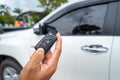 Hand pressing the button on the remote to lock or unlock the car Royalty Free Stock Photo