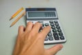 Hand pressing on calculator for calculating cost estimating. Royalty Free Stock Photo