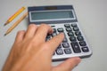 Hand pressing on calculator for calculating cost estimating. Royalty Free Stock Photo