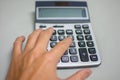 Hand pressing on calculator for calculating cost estimating. Royalty Free Stock Photo