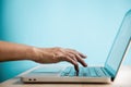 Hand Pressing Computer Keyboard. Side View. Closeup shot and Selective Focus on Finger. Person using Laptop for Working on Desk Royalty Free Stock Photo