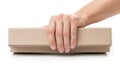 A hand is pressing down on a closed rectangular cardboard box Royalty Free Stock Photo