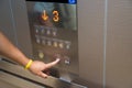 The hand is pressing the elevator control button Royalty Free Stock Photo