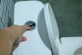 Hand pressing the flush button Royalty Free Stock Photo