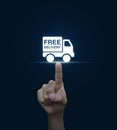 Hand pressing free delivery truck icon on blue background, Trans Royalty Free Stock Photo