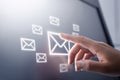 Hand pressing a glowing digital email icon for instant communication. Royalty Free Stock Photo