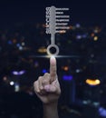 Hand pressing key with business words over blurred light city to Royalty Free Stock Photo