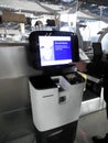 A hand pressing on monitor, Self check-in machine at the airport, loading baggage, self bag drop Royalty Free Stock Photo