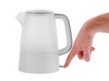 Hand pressing the power button of an electric kettle plastic underneath on a white isolated background Royalty Free Stock Photo