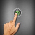 Hand pressing power button on metalic background Royalty Free Stock Photo