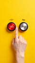Hand pressing red YES button on yellow background decision concept Royalty Free Stock Photo