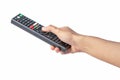 Hand pressing remote control TV television with clipping path Royalty Free Stock Photo