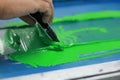 Hand pressing silk-screen printing, close up view Royalty Free Stock Photo
