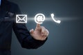 Hand pressing telephone, email button icon over blue Royalty Free Stock Photo