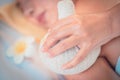 Hand pressing hot compress for Spa and massage treatment on woman back, closed up shot Royalty Free Stock Photo