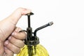 Hand pressuring yellow spray glass bottle isolate Royalty Free Stock Photo