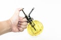 Hand pressuring yellow spray glass bottle isolate Royalty Free Stock Photo