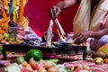 Hand of a priest worshiping hindu god with fire and yagna ritual