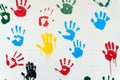 Hand prints in many colors on a white wall Royalty Free Stock Photo