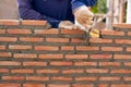 Hand of professional construction worker laying bricks In wall construction, construction and masonry concept Royalty Free Stock Photo