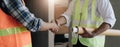 Hand in hand between project contractors and customers due to negotiation of expenses and investments, construction and Royalty Free Stock Photo