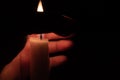 A hand protecting a candle against wind Royalty Free Stock Photo
