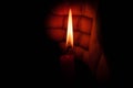 Hand protecting candle light from the wind Royalty Free Stock Photo
