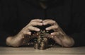 Hand protecting coins stacking with plant growth on the table. Money saving dividend yield and return profit investment concept Royalty Free Stock Photo