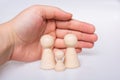 Hand protecting wooden figurines of people as family concept Royalty Free Stock Photo