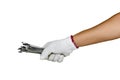 A hand with protection glove holding various spanners Royalty Free Stock Photo