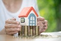 Hand protection, house model on top of stack of money as growth of mortgage credit, Concept of property management. Invesment and Royalty Free Stock Photo
