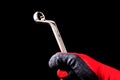 Hand with protective gloves holding Box End Wrench key tool Royalty Free Stock Photo